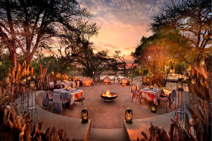 Private candlelit bush dinner under the stars during a Serengeti safari buyout