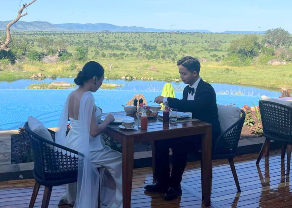 Couple celebrating a safari vow renewal ceremony in the Serengeti savannah in Tanzania