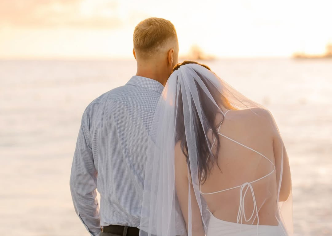 Romantic Zanzibar beach vow renewal ceremony at sunset on a white sand beach
