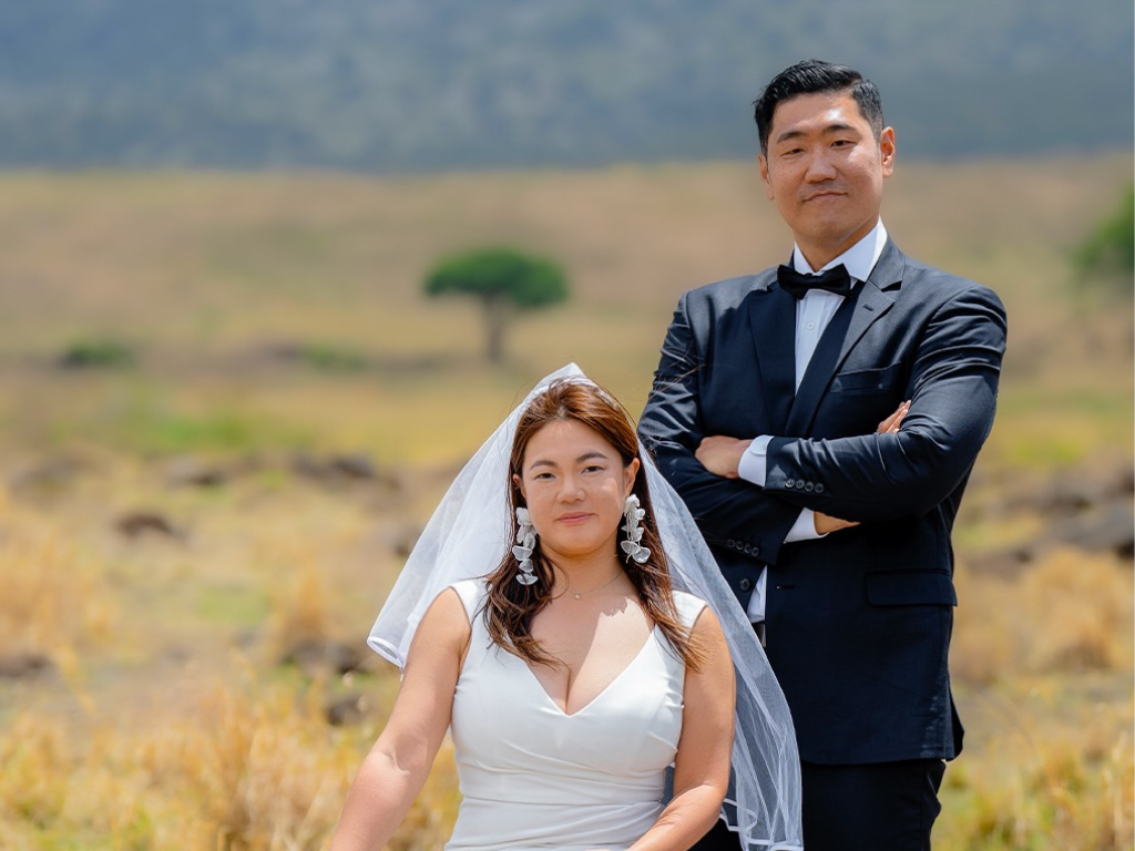Couple celebrating their destination wedding in Tanzania with stunning safari landscape backdrop