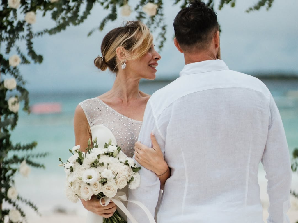 Couple at Zanzibar beach wedding during peak dry season June to October with turquoise ocean and brilliant sunshine