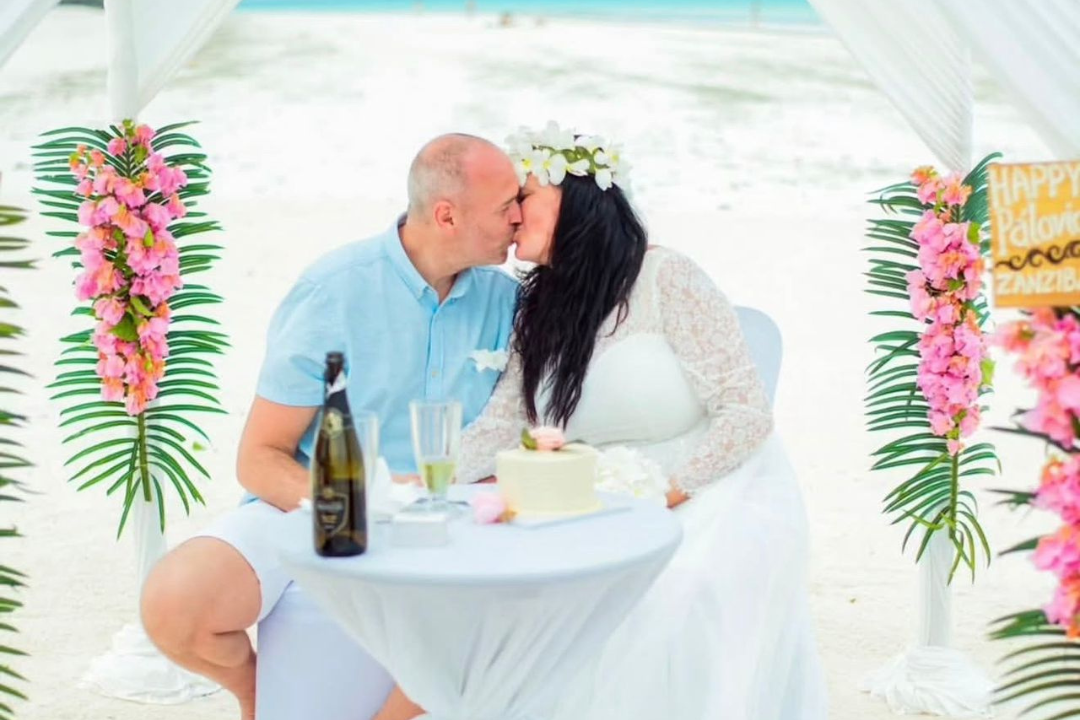 Luxury destination wedding altar setup on Nakupenda Sandbank in Zanzibar surrounded by turquoise ocean water.