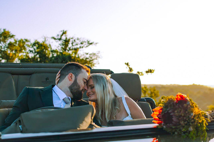Couple exchanging vows during a luxury Serengeti wedding, part of an adventure elopement package in Africa