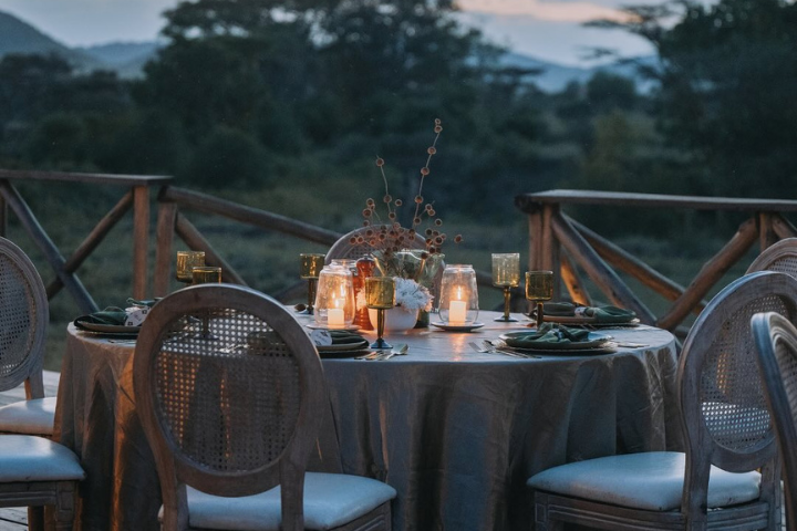 Couple enjoying a romantic bush dinner in the Serengeti under the stars