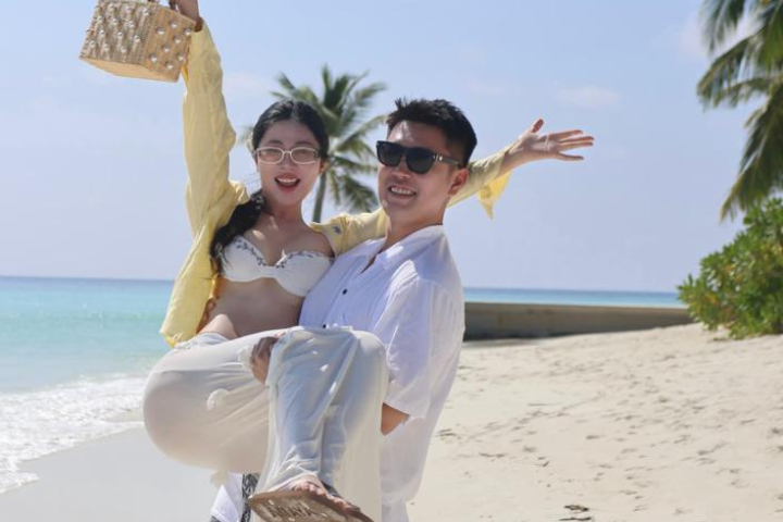 Couple walking on the white sand beaches of Zanzibar during their honeymoon